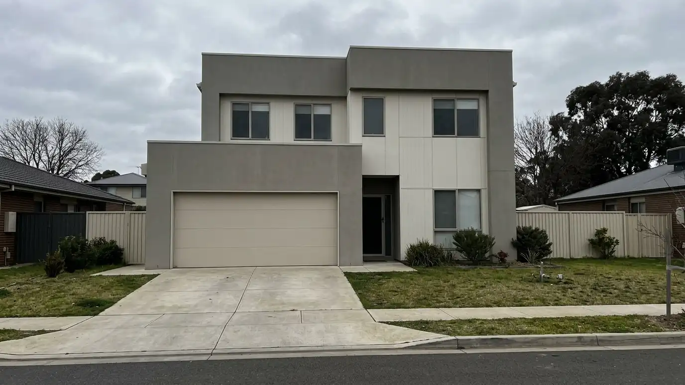 Before: a modern home with a plain beige flat-panel door on a bland front
