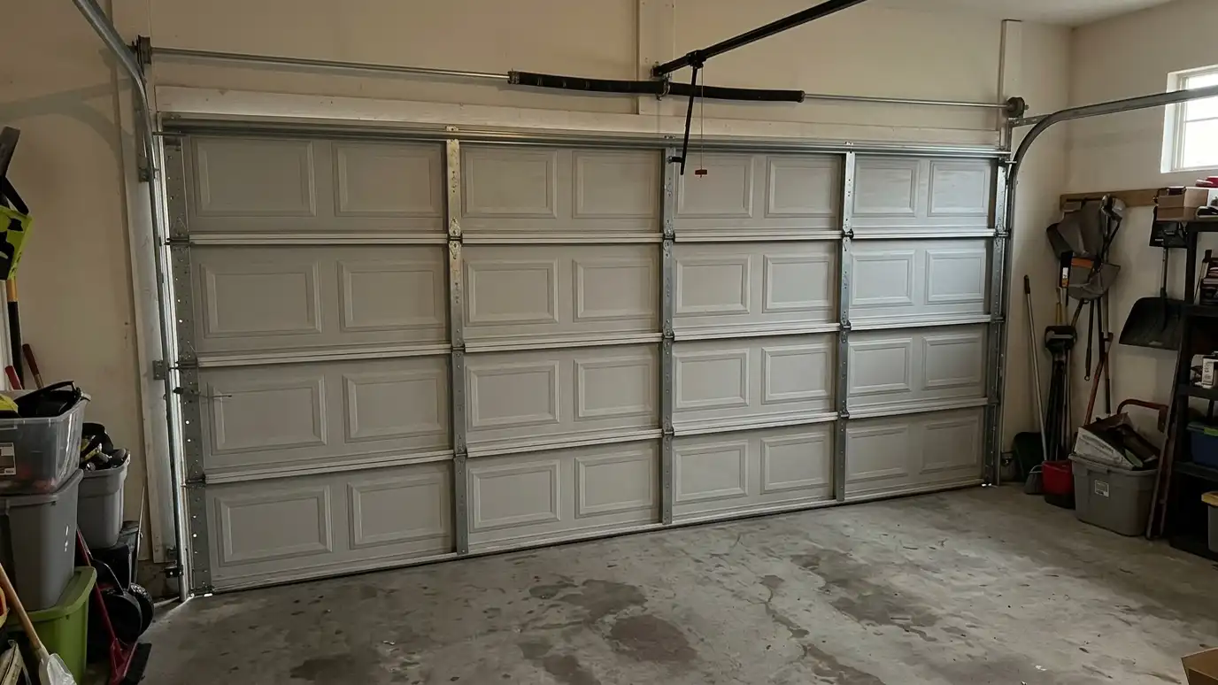 After: A door off its track made straight and safe | Music City Garage Door Service After: a garage door with the same door repaired, level in its tracks and closing neatly